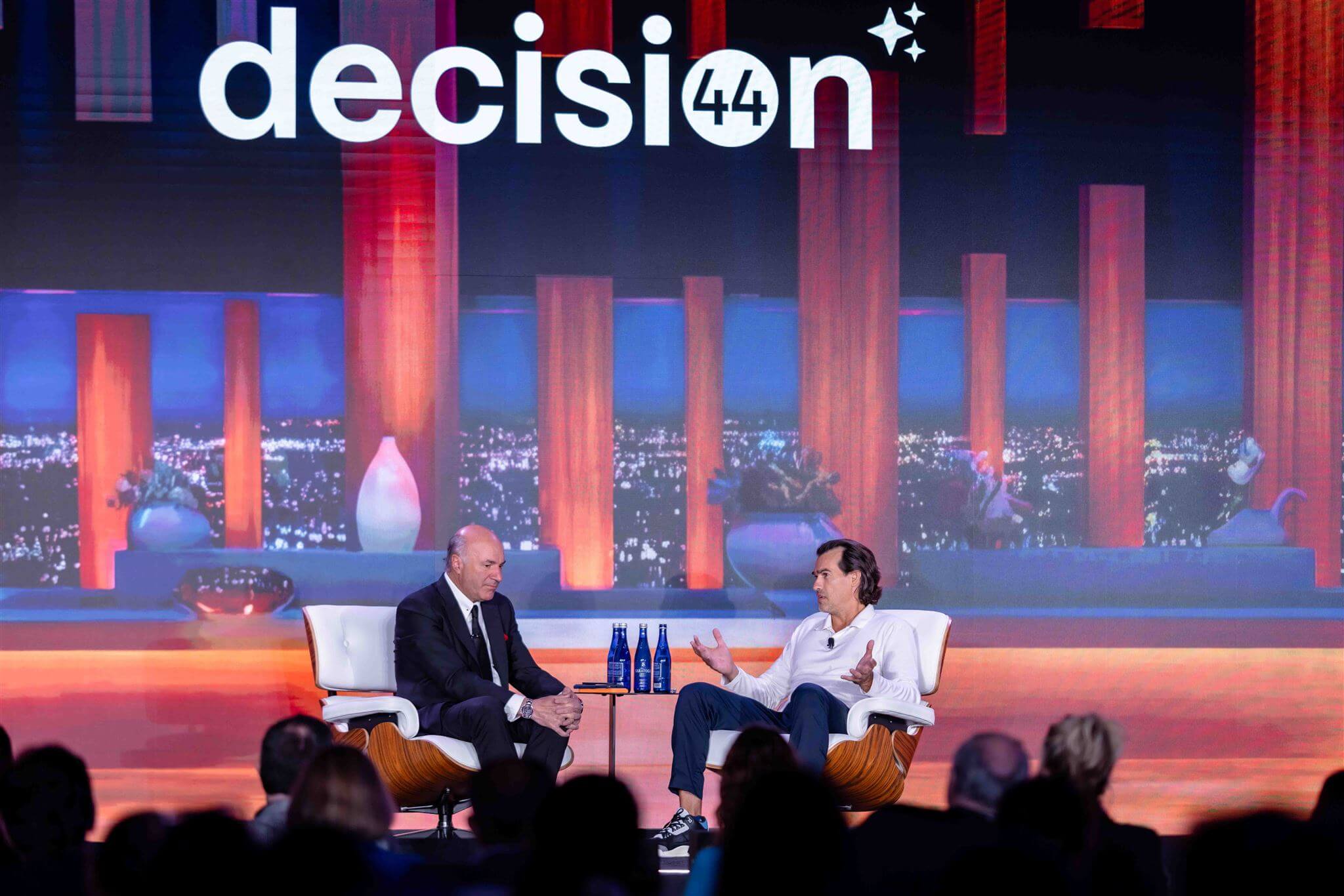Kevin O'Leary and Jett McCandless on stage at decision44 Chicago with decision44 branding displayed
